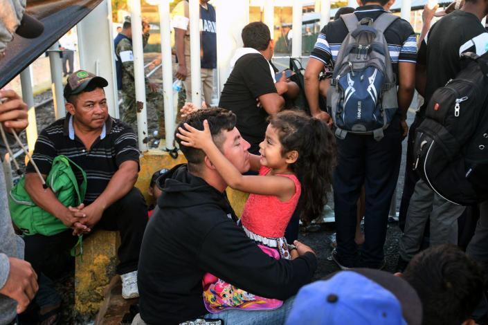 <p>A Honduran migrant and his daughter, who are taking part in a caravan heading to the U.S., rest as they wait to cross the border from Tecun Uman in Guatemala to Ciudad Hidalgo, Mexico, on Oct. 22, 2018. (Photo: Orlando Sierra/AFP/Getty Images) </p>