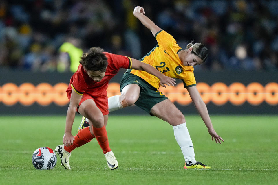 China's Wang Shuang, left, and Australia's Kyra Cooney-Cross battle for the ball during the women's international soccer friendly between China and Australia at Stadium Australia, in Sydney, Monday, June 3, 2024. (AP Photo/Rick Rycroft)