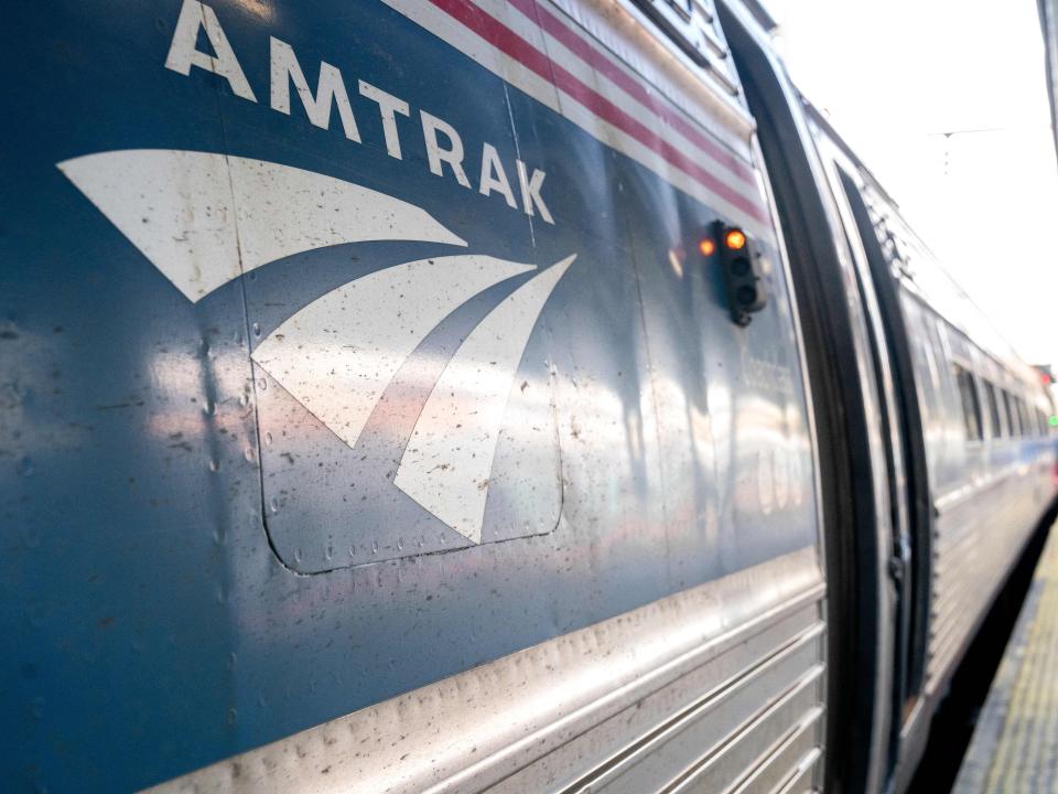 The Amtrak logo on a train at a station