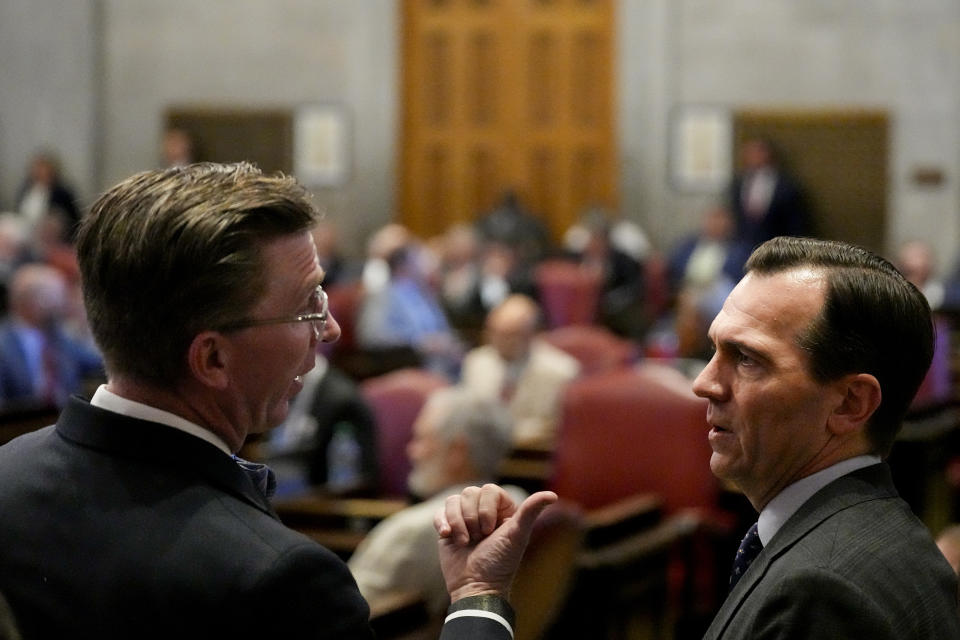 Rep. Ryan Williams, R-Cookeville, left, speaks with Rep. John Ray Clemmons, D-Nashville, on the House floor during a legislative session Thursday, April 25, 2024, in Nashville, Tenn. (AP Photo/George Walker IV)