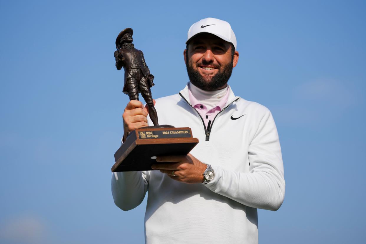 Apr 22, 2024; Hilton Head, South Carolina, USA; Scottie Scheffler poses for a photo with the trophy after winning the RBC Heritage golf tournament. Play was suspended on Sunday, due to inclement weather. Mandatory Credit: Aaron Doster-USA TODAY Sports