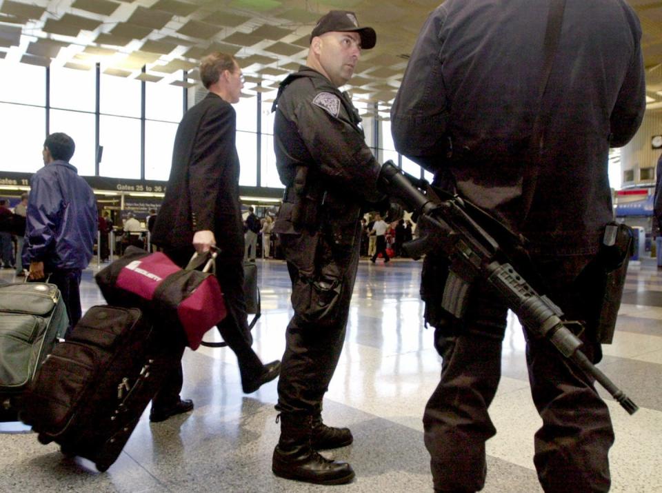 <span class="caption">Heavily armed guards were a common sight at airports in the days after 9/11.</span> <span class="attribution"><span class="source">AP Photo/Michael Dwyer</span></span>