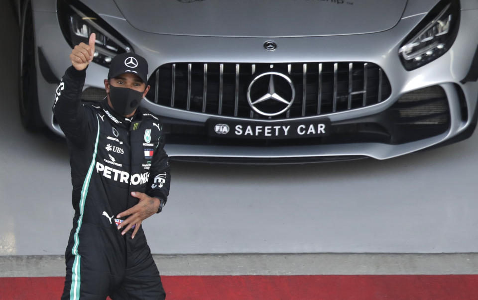 Mercedes driver Lewis Hamilton of Britain gives the thumbs up after clocking the fastest time during the qualifying session for the upcoming Russian Formula One Grand Prix, at the Sochi Autodrom circuit, in Sochi, Russia, Saturday, Sept. 26, 2020. The Russian Formula One Grand Prix will take place on Sunday. Hamilton will start in pole position for Sunday's race. (AP Photo/Pavel Golovkin, Pool)