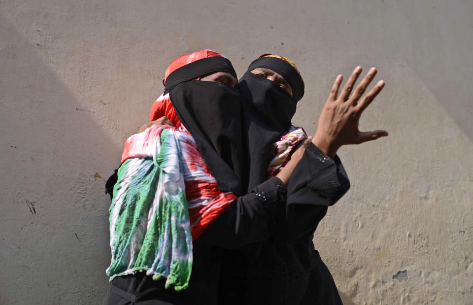 Bangladeshi women mourn as they wait outside a morgue in Dhaka, Bangladesh, Thursday, Feb. 21, 2019. A devastating fire raced through at least five buildings in an old part of Bangladesh's capital and killed scores of people. (AP Photo/Mahmud Hossain Opu )