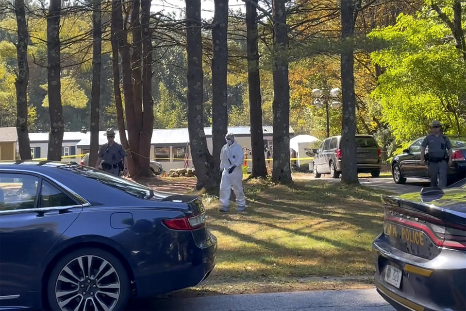 In this image taken from video, New York State police and crime scene investigators walk across the property, Tuesday, Oct. 3, 2023, in Milton, N.Y., where Craig N. Ross Jr. was found with 9-year-old Charlotte Sena, who he is suspected of kidnapping. A fingerprint on a ransom note led police to the kidnapping suspect's camper in New York where Sena was found hidden in a cabinet, ending a two-day search sparked by the girl's disappearance during a family camping trip, officials said. (AP Photo/Maysoon Kahn)