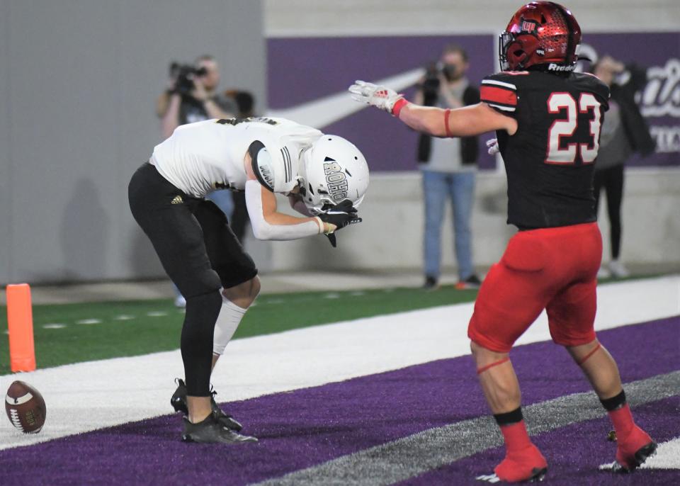 Rider's Reese Frantom, left, reacts after an incomplete pass in the end zone in the Region I-5A Division II final Friday, Dec. 3, 2021, at Wildcat Stadium in Abilene.
