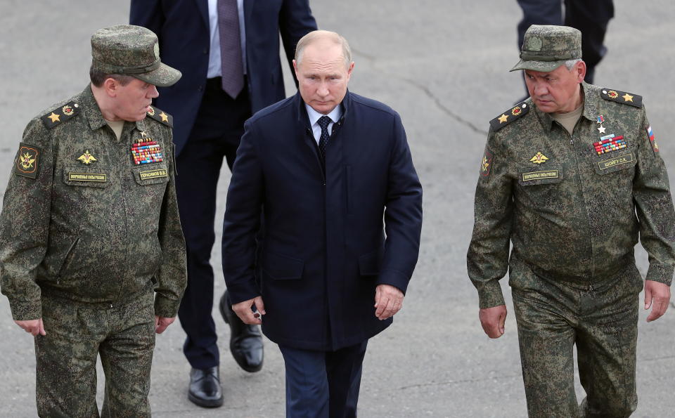 Russian President Vladimir Putin (center), Defense Minister Sergei Shoigu (left) and Chief of the General Staff of Russian Armed Forces Valery Gerasimov visit a training ground to observe military exercises carried out by Russian and Belarusian forces in September 2021. / Credit: Sputnik/Sergei Savostyanov/Pool via REUTERS