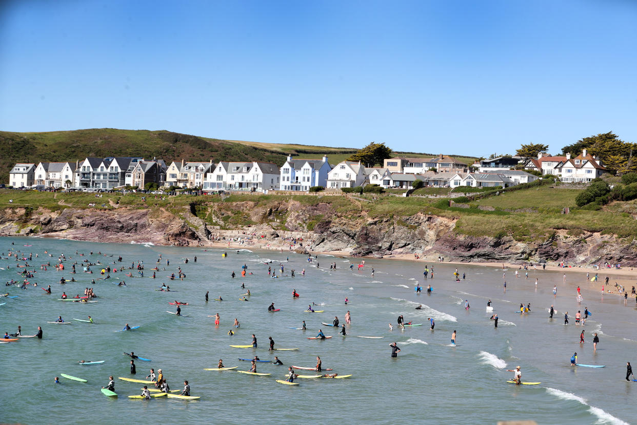 POLZEATH, ENGLAND - JULY 21: Beachgoers enjoy Polzeath beach on July 21, 2020 in Polzeath, United Kingdom. Many UK residents have decided to go on 'staycations' to Devon and Cornwall this summer during the pandemic. (Photo by Chris Jackson/Getty Images)