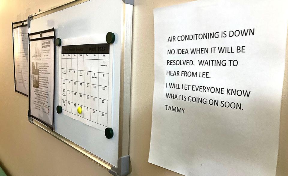 Sign posted next to a bulletin board on one of the floors of the Essex House on Wednesday states that the building's central air conditioning is not working.