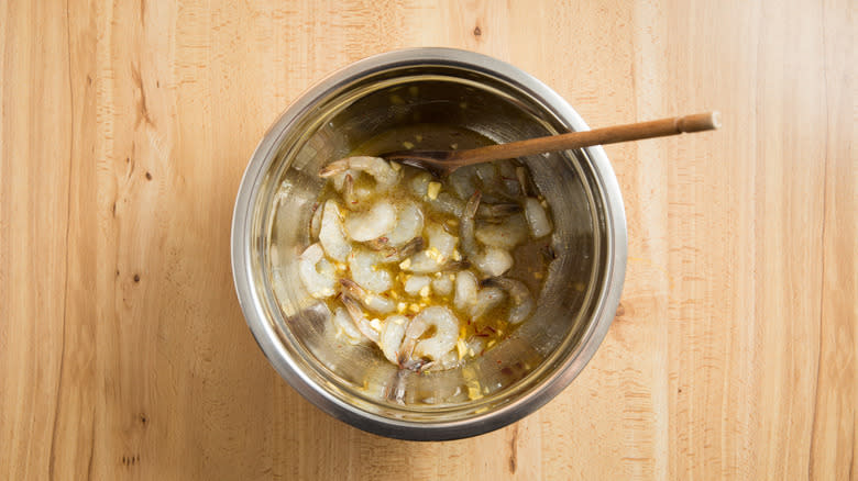 shrimp marinating in mixing bowl 