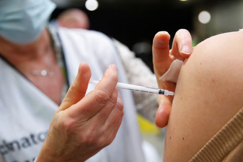 FILE PHOTO: People receive booster dose of coronavirus disease (COVID-19) vaccine in Antwerp