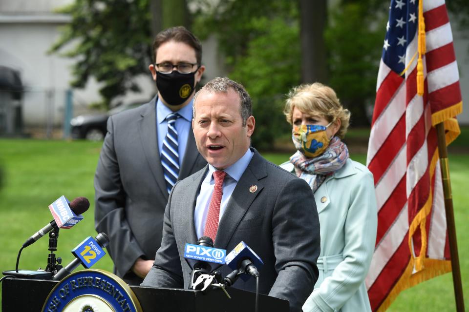 U.S. Rep. Josh Gottheimer talks about how New York City's congestion pricing will affect New Jersey commuters, in Paramus, N.J., on Monday May 10, 2021. In the background are N.J. Assemblyman Chris Tully and N.J. Assemblywoman Lisa Swain.