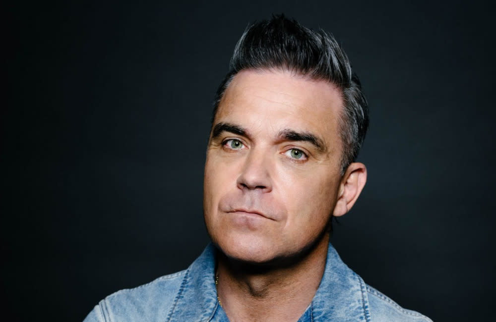 Robbie Williams slashed his wrists as he struggled to cope with fame credit:Bang Showbiz