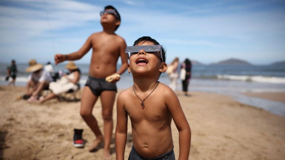 Children watching on the beach in Mazatlan, Mexcio the first place to experience wholeness