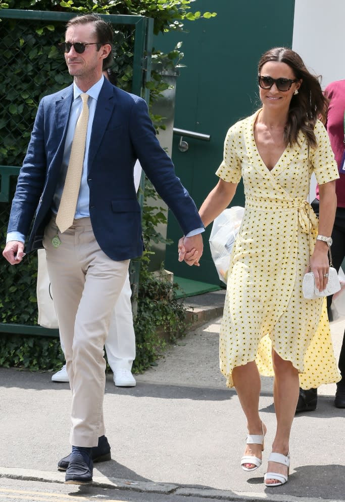 Pippa Middleton wearing a floral yellow Ganni dress and white sandals with husband James Matthews at Wimbledon on July 12. - Credit: Shutterstock