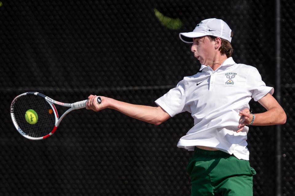 Duxbury sophomore 1st singles player Tim Vargas returns a shot from Hopkinton's Lex Kaye, during the Division 2 state semifinal at Lexington High, June 15, 2023.