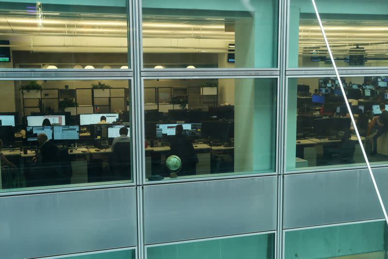 People work on the trading floor at the global headquarters of Goldman Sachs investment banking firm in New York