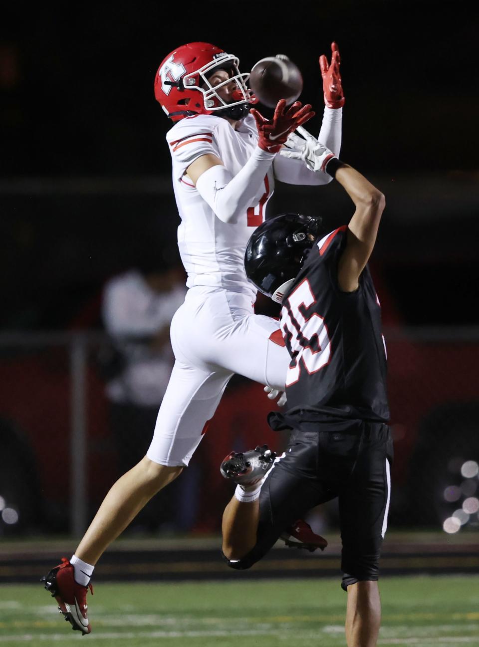 American Fork’s Jett Nelson goes up for a catch over West’s Justice Reed during play in Salt Lake City on Friday, Aug. 25, 2023. American Fork won 45-21. | Scott G Winterton, Deseret News