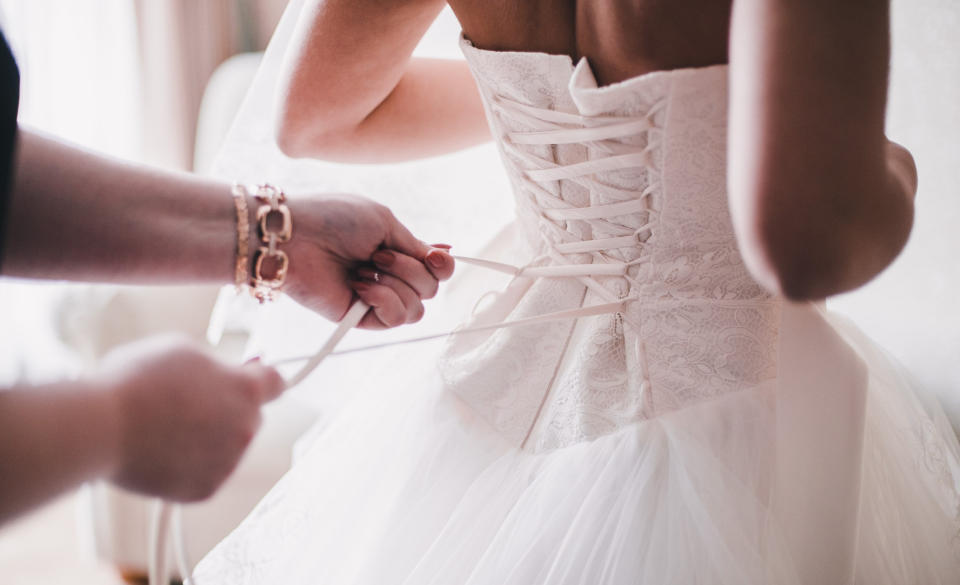 The bride pretended her bridesmaids' dresses cost more than they did [Photo: Getty]