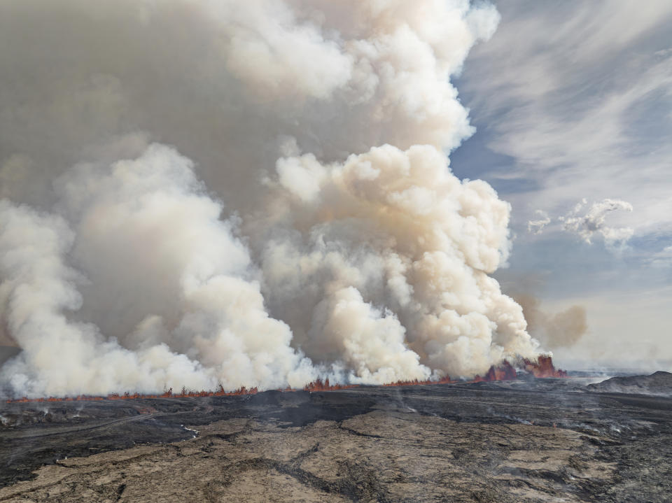 An eruptive fissure spews lava and smoke from a volcano in Grindavik, Iceland, Wednesday, May 29, 2024. A volcano in southwestern Iceland erupted Wednesday for the fifth time since December, spewing red lava that once again threatened the coastal town of Grindavik and led to the evacuation of the popular Blue Lagoon geothermal spa. (AP Photo/Marco di Marco)