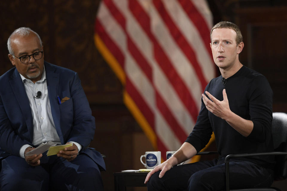 Facebook CEO Mark Zuckerberg speaks at Georgetown University, Thursday, Oct. 17, 2019, in Washington. At left is Mo Elleithee, the founding Executive Director of Georgetown University's Institute of Politics and Public Service. (AP Photo/Nick Wass)