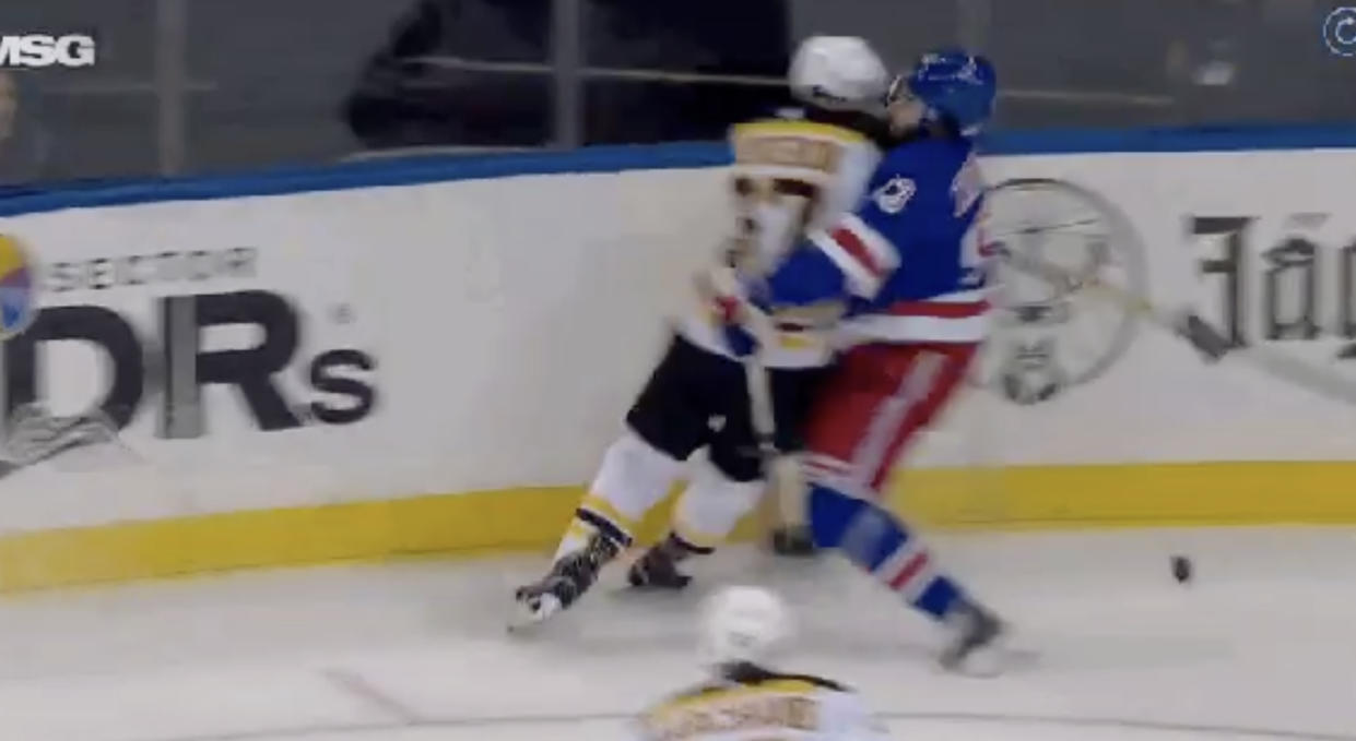 Rangers' Mika Zibanejad absorbs all of Bruins' Patrice Bergeron late in the first period on Sunday night. (Twitter//@HeresYourReplay)