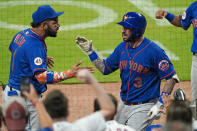 New York Mets' Tomas Nido (3) celebrates with Jonathan Villar (1) after hitting a solo home run during the ninth inning of the team's baseball game against the Atlanta Braves on Tuesday, May 18, 2021, in Atlanta. (AP Photo/John Bazemore)