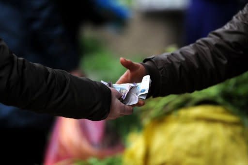 A local resident buys vegetables at a market in Hefei, east China's Anhui province, last month. China's inflation rate edged up in March from the previous month, according to official data, but analysts said they expect it to continue its downward trend