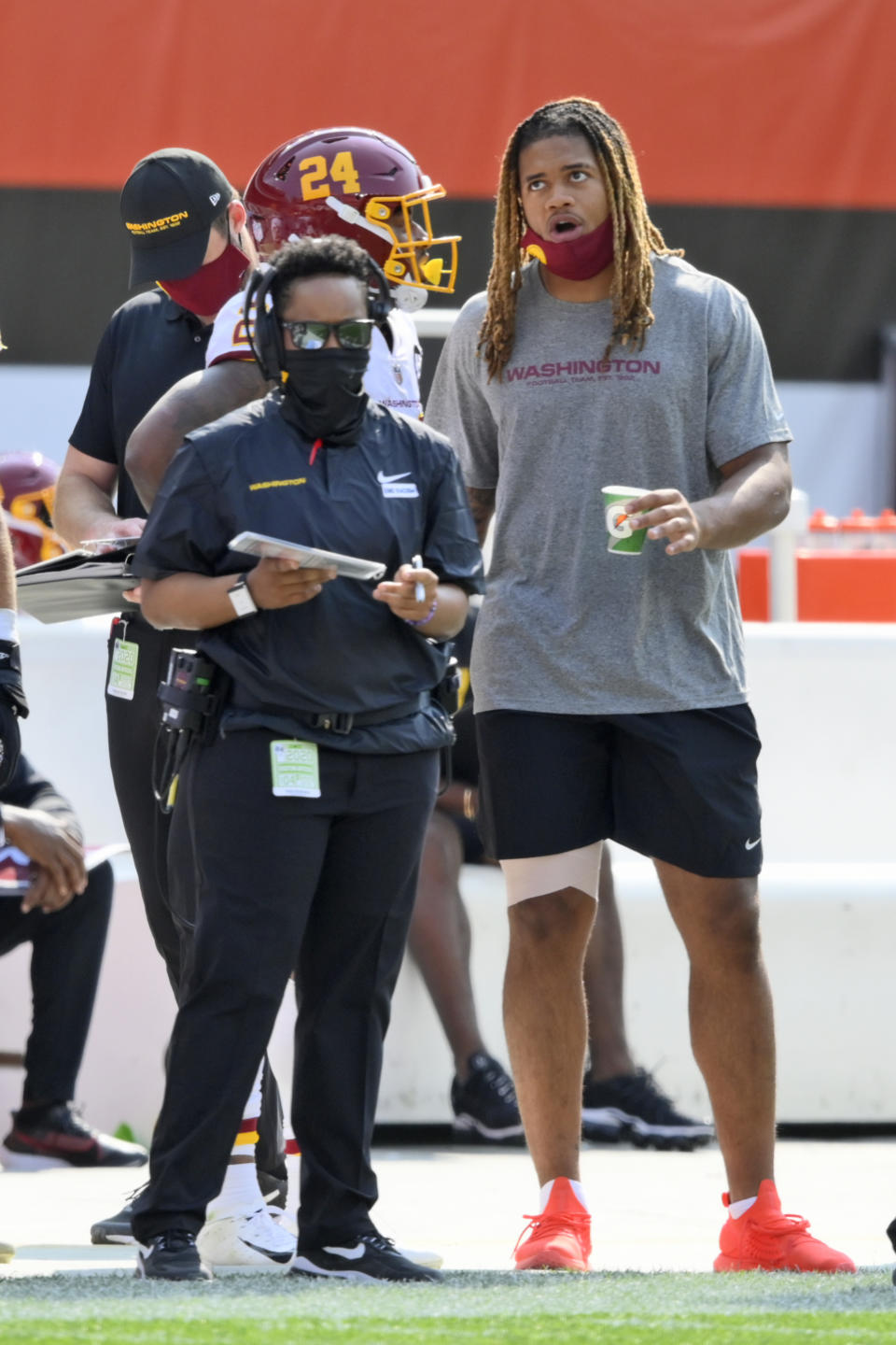 Washington Football Team defensive end Chase Young, right, watches form the sidelines during the second half of an NFL football game against the Cleveland Browns, Sunday, Sept. 27, 2020, in Cleveland. (AP Photo/David Richard)