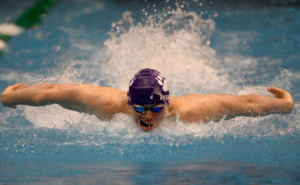 Jackson’s Ezra Herring competes in the boys 100-yard butterfly in the Division I district meet at Cleveland State, Saturday, Feb. 17, 2024.