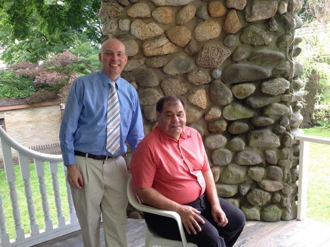 Bill Pavao, left, and Len Rebello sit on the porch of Maplecroft, Lizzie Borden's post-trial home, in 2015.