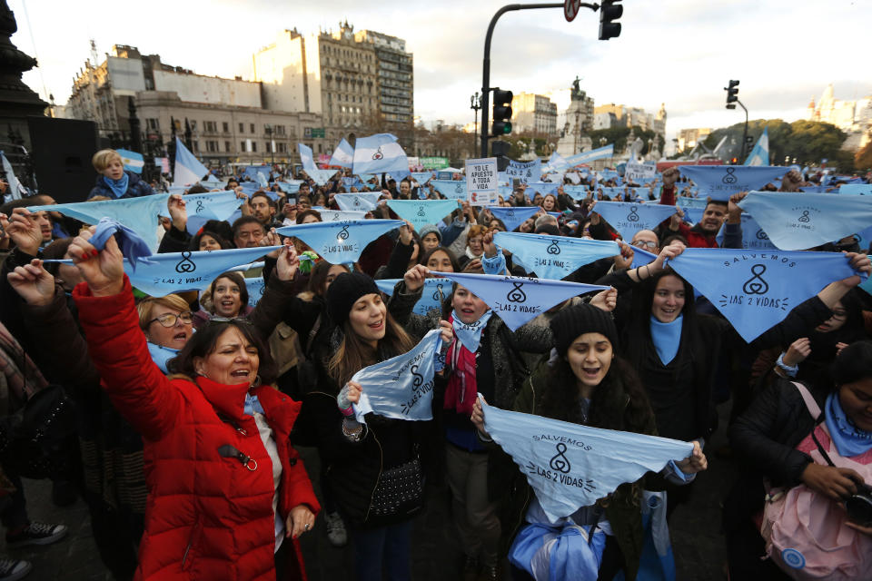 In this July 3, 2018 photo, women stage an anti-abortion protest as an abortion rights bill is discussed in the Senate, in Buenos Aires, Argentina. The measure only narrowly passed in the lower house of Congress after a long campaign by hundreds of feminist and human rights groups. Its advance appears to have galvanized opponents to mobilize public protests ahead of a Senate vote tentatively set for Aug. 8. (AP Photo/Jorge Saenz)