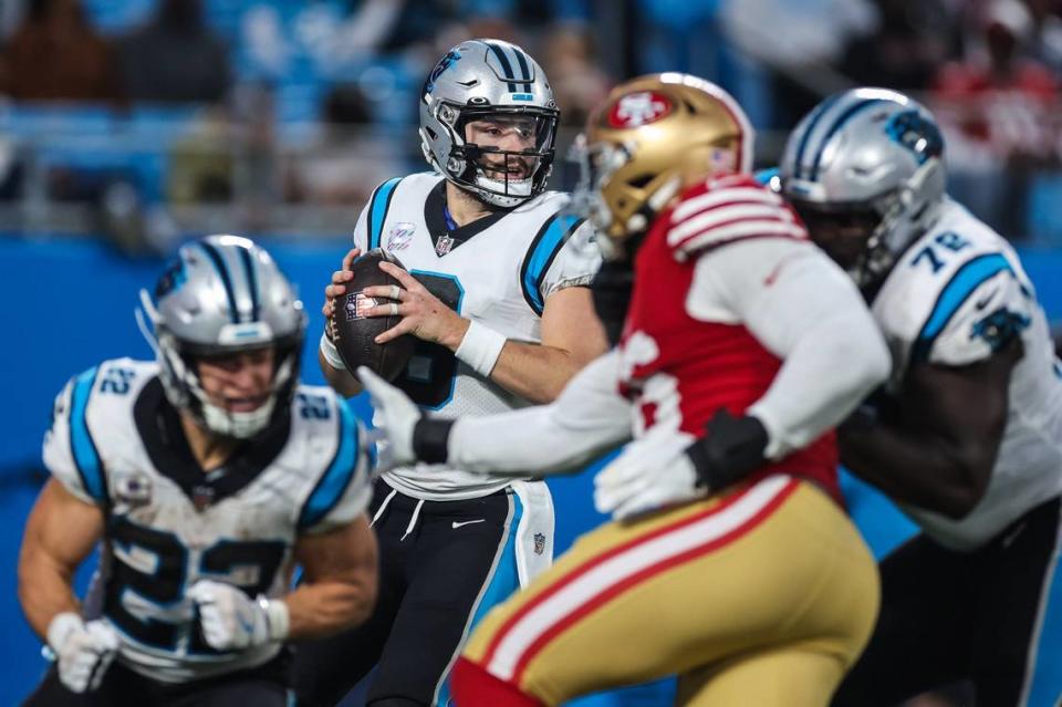 Panthers offense keeps 49ers defense from quarterback Baker Mayfield, center, during the game at Bank of America Stadium on Sunday, October, 9, 2022.