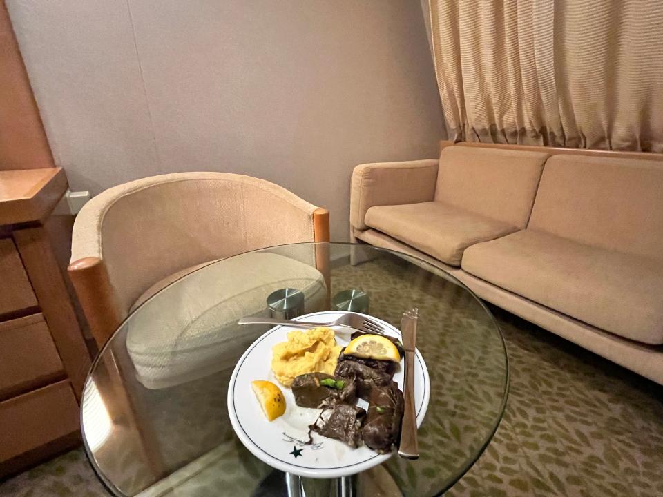 plate of food on a glass table in a ferry cabin in greece