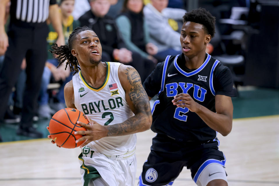 Baylor guard Jayden Nunn (2) drives past BYU guard Jaxson Robinson (2) during the first half of an NCAA college basketball game Tuesday, Jan. 9, 2024, in Waco, Texas. (AP Photo/Gareth Patterson)