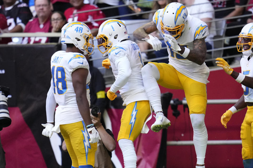 Los Angeles Chargers wide receiver DeAndre Carter, center, celebrates his touch with tight end Stone Smartt (48) and wide receiver Keenan Allen, right, during the first half of an NFL football game against the Arizona Cardinals, Sunday, Nov. 27, 2022, in Glendale, Ariz. (AP Photo/Ross D. Franklin)