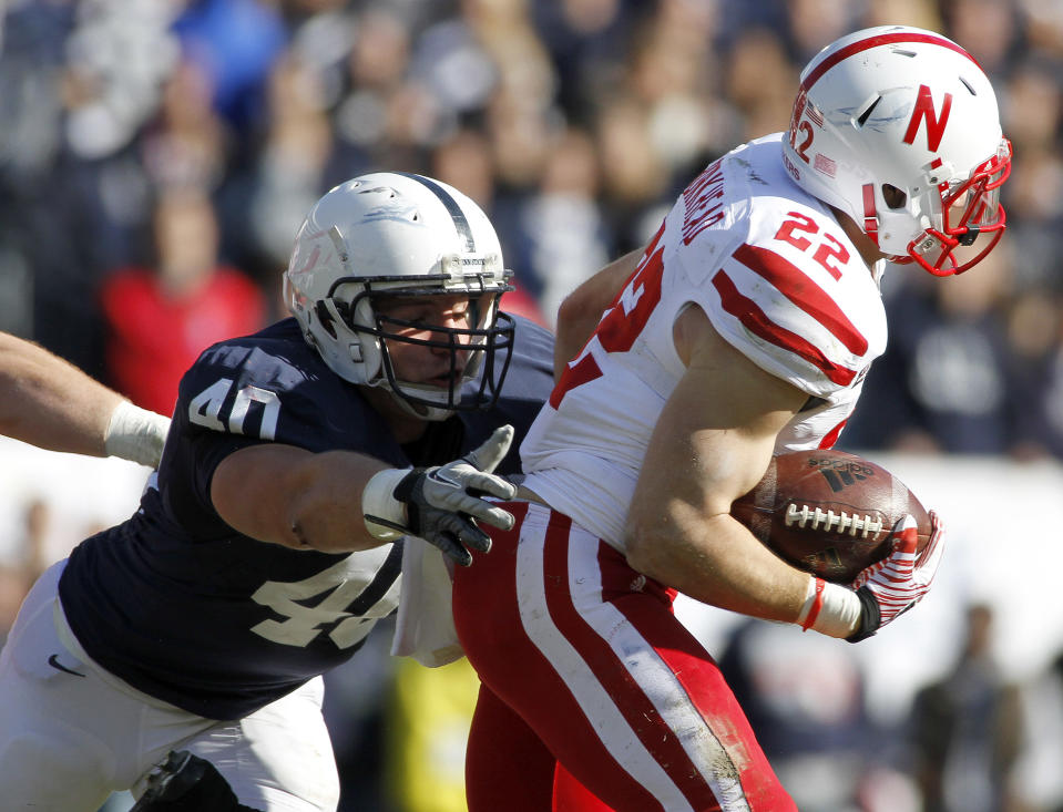 STATE COLLEGE, PA - NOVEMBER 12: Glenn Carson #40 of the Penn State Nittany Lions tackles Rex Burkhead #22 of the Nebraska Cornhuskers during the game on November 12, 2011 at Beaver Stadium in State College, Pennsylvania. (Photo by Justin K. Aller/Getty Images)