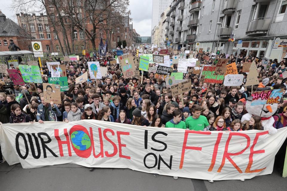 Swedish climate activist Greta Thunberg, center in first row behind the banner, attends the 'Friday For Future' rally in Berlin, Germany, Friday, March 29, 2019. Thousands of students are gathering in the German capital, skipping school to take part in a rally demanding action against climate change. (Michael Kappeler/dpa via AP)