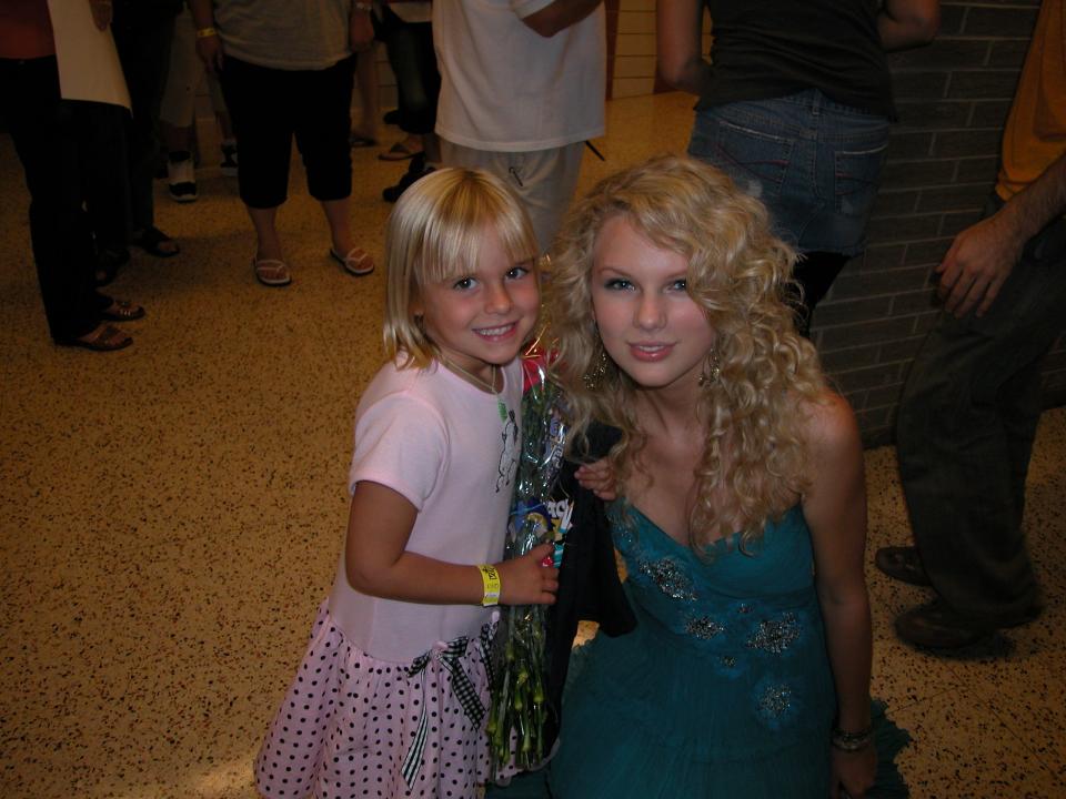 Singer Taylor Swift poses with a young girl who attended her concert on Aug. 15, 2006, at Alliance High School. Swift was one of the opening acts for a fundraiser show for the Greater Alliance Carnation Festival.