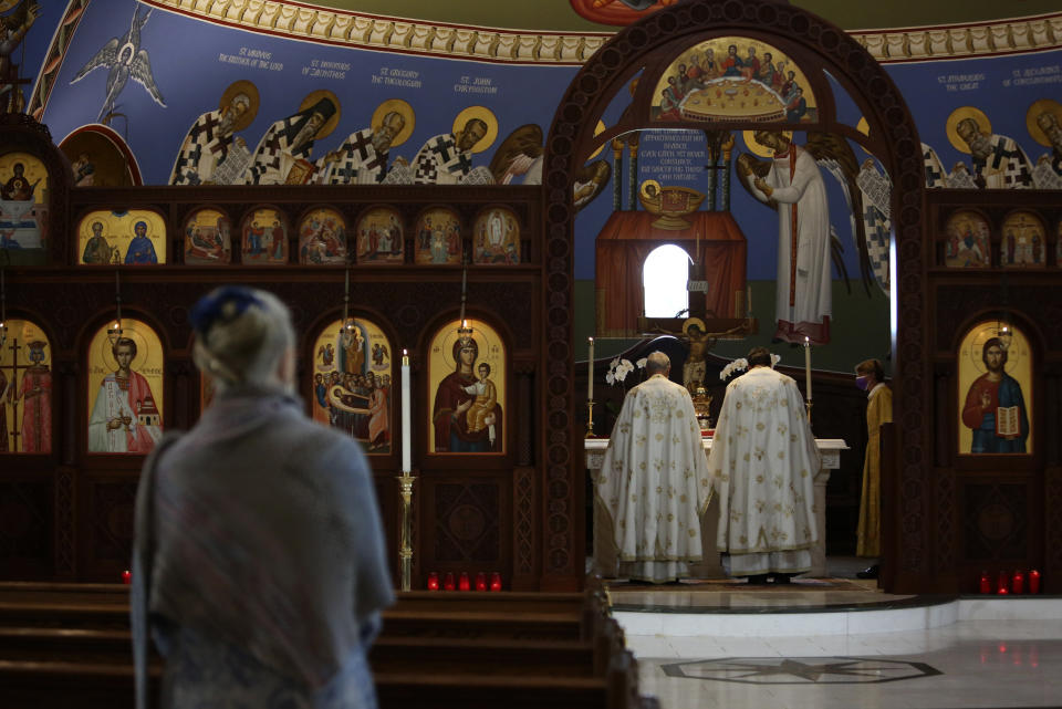 The Rev. Alex Karloutsos, vicar-general for the Greek Orthodox Archdiocese of America, and the Rev. Constantine Lazarakis lead worship at the Formation of the Virgin Mary Greek Orthodox Church of the Hamptons on Sunday, Aug. 29, 2021, in Southhampton, N.Y. In the hours and days after the Sept. 11, 2001 attacks, Karloutso was among clergy offering spiritual support to emergency responders in the hours and days after the Sept. 11, 2001 attacks and has since played a significant role in the reconstruction of St. Nicholas Greek Orthodox Church and National Shrine at ground zero. (AP Photo/Jessie Wardarski)