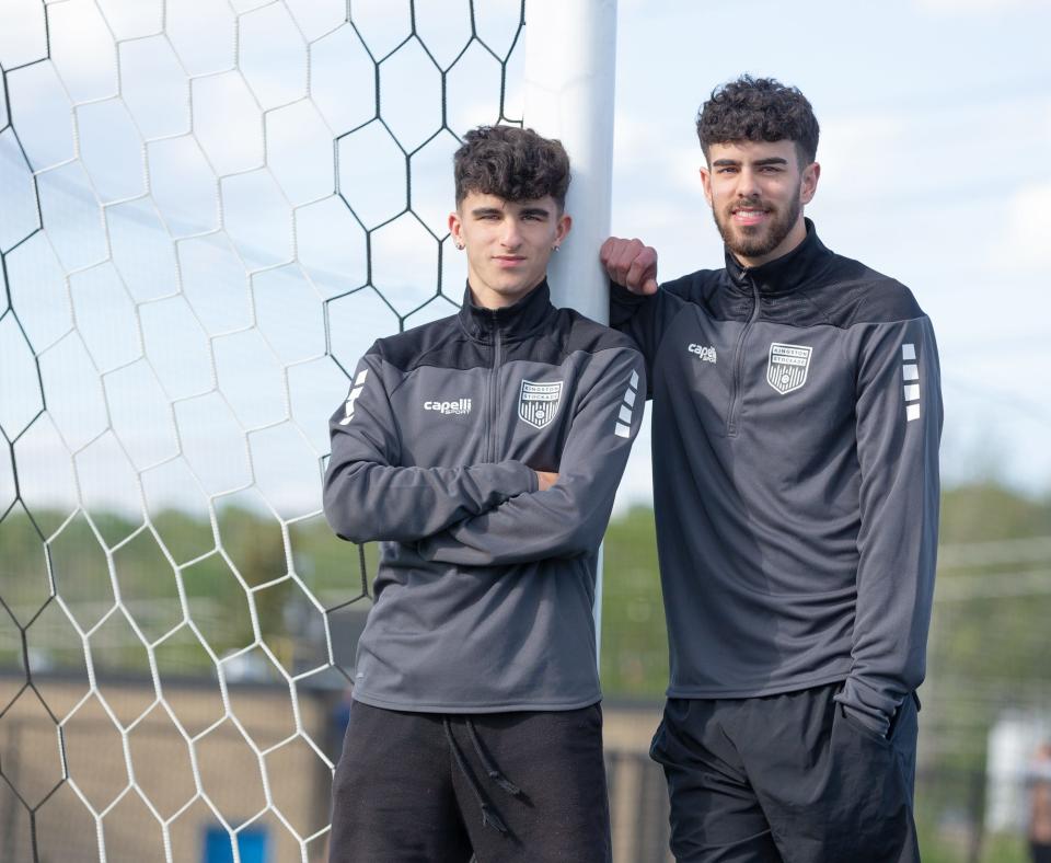 Brothers Zach, left, and Matt Rabadi, who now are teammates on the Kingston Stockade, pose on the soccer field at John Jay-East Fishkill High School.