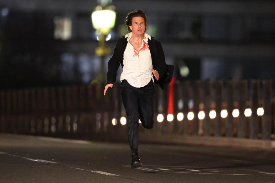 In photos obtained by The Post, Cruise, 61, can be seen sporting shaggy brunette hair and a white shirt drenched in fake blood and covered by a black coat as he sprints across Westminster Bridge as London’s Big Ben and the Palace of Westminster provide a breathtaking backdrop. Click News and Media/MEGA/SplashNews.com