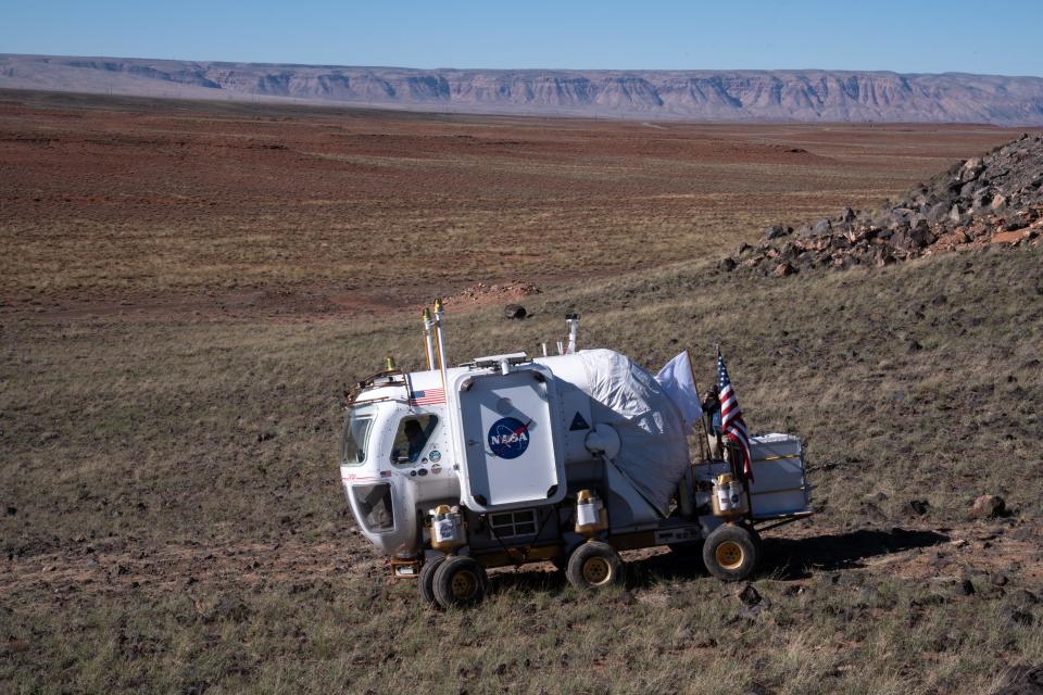 Lucien Junkin (NASA Space Exploration Vehicle chief engineer) drives the Artemis Rover during a news briefing on Oct. 24, 2022, at NASA's Desert Research and Technology Studies (Deserts RATS) Artemis' Rover Mission Simulations site at Black Point Lava Flow, located 40 miles north of Flagstaff.