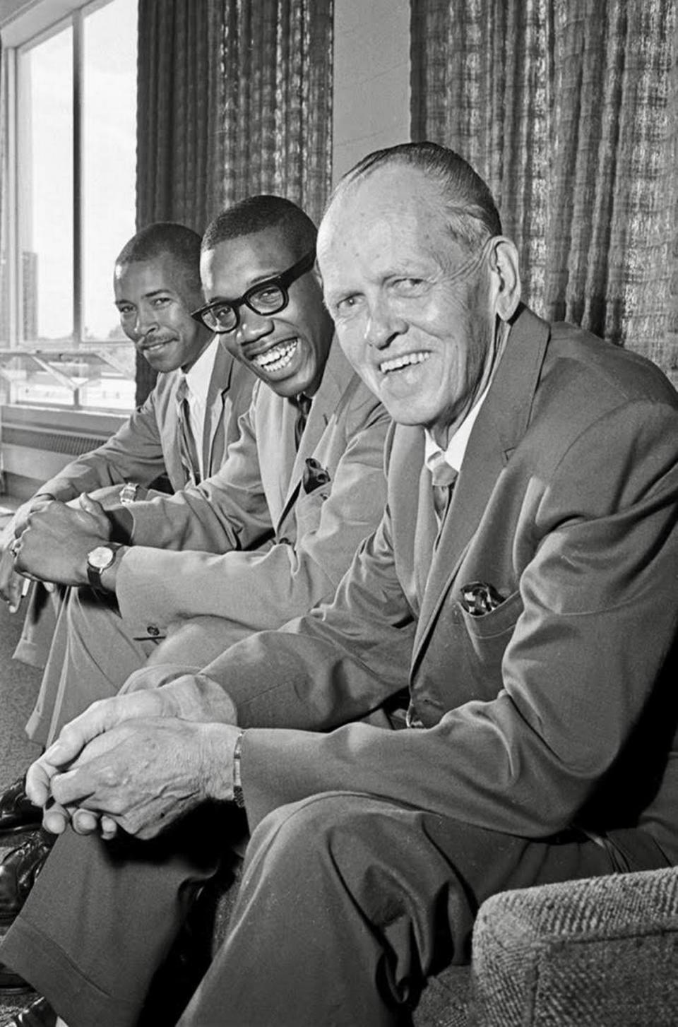 James Cash, center, signed a letter of intent with TCU Basketball Coach Buster Brannon and the I. M. Terrell all-stater became the first to break the color line in Southwest Conference basketball. Cash’s coach, Robert Hughes, is pictured at left.