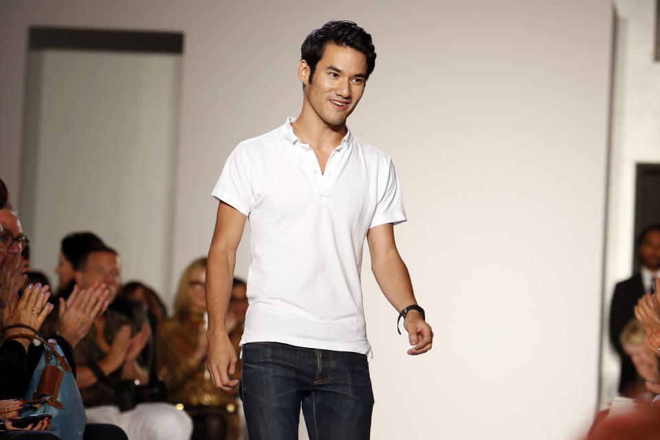 Designer Joseph Altuzarra acknowledges the audience after the Altuzarra Spring 2014 collection show during Fashion Week, Saturday, Sept. 7, 2013, in New York. (AP Photo/Jason DeCrow)