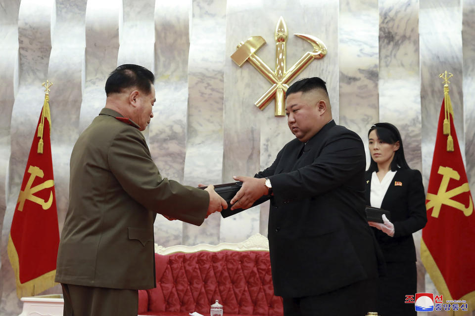 In this Sunday, July 26, 2020, photo released by the North Korean government, North Korean leader Kim Jong Un, center, hands over a “Paektusan” commemorative pistol to a senior military official during a ceremony in Pyongyang, North Korea. At right is Kim's powerful sister Kim Yo Jong. Independent journalists were not given access to cover the event depicted in this image distributed by the North Korean government. The content of this image is as provided and cannot be independently verified. Korean language watermark on image as provided by source reads: "KCNA" which is the abbreviation for Korean Central News Agency. (Korean Central News Agency/Korea News Service via AP)