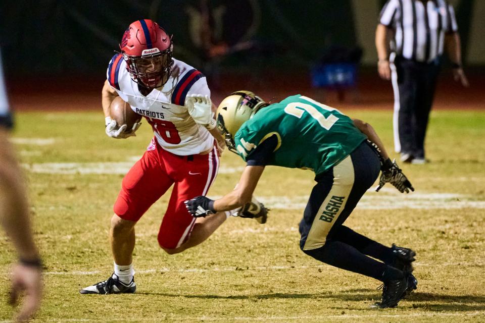 American Leadership Academy Patriots wide receiver Taylor Searle (18) attempts to block a tackle from Basha Bears defensive back Trey Knox (24) at Basha High School in Chandler on Friday, Nov. 17, 2023. Alex Gould/Special for The Republic