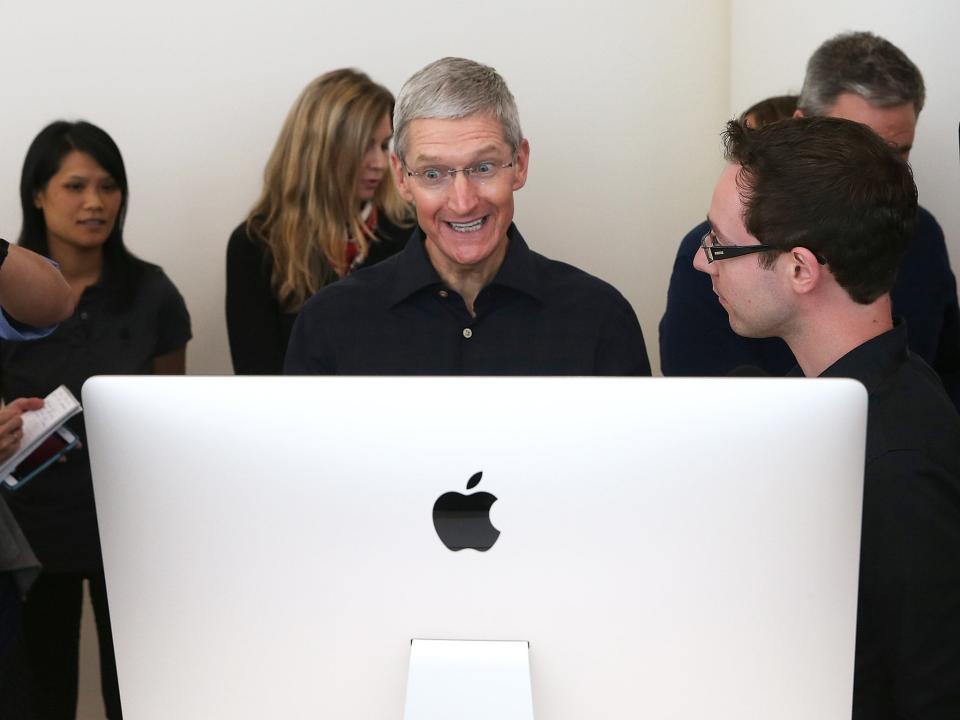 Apple CEO Tim Cook looks at the new 27 inch iMac (Getty Images)