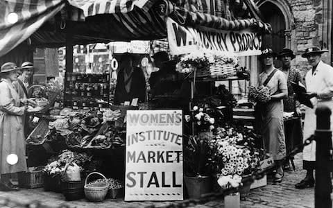 A Women's Institute of a WI stall in Saffron Walden market in the 1930 - Credit: PA