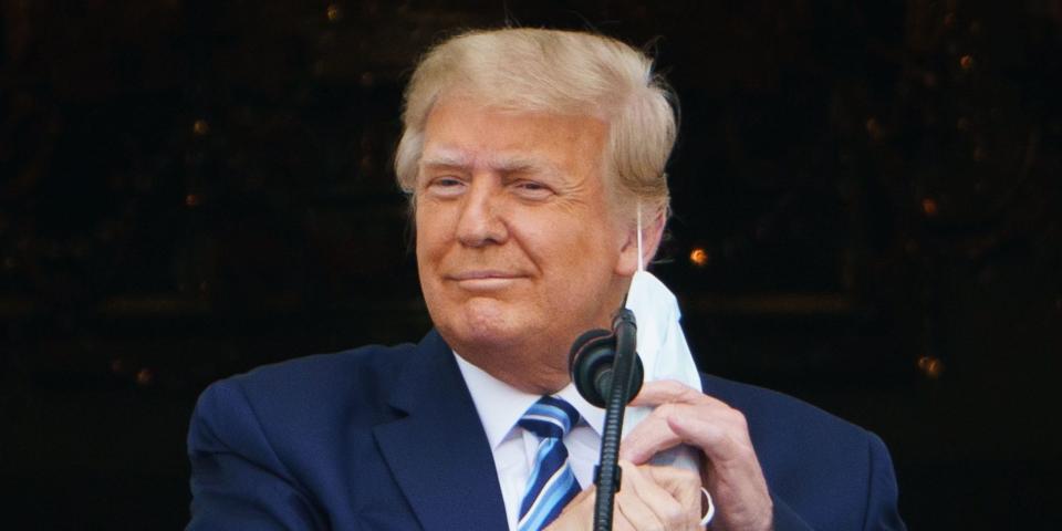 Then-President Donald Trump taking his mask off before speaking at a rally from the South Portico of the White House in Washington, DC on October 10, 2020 shows.